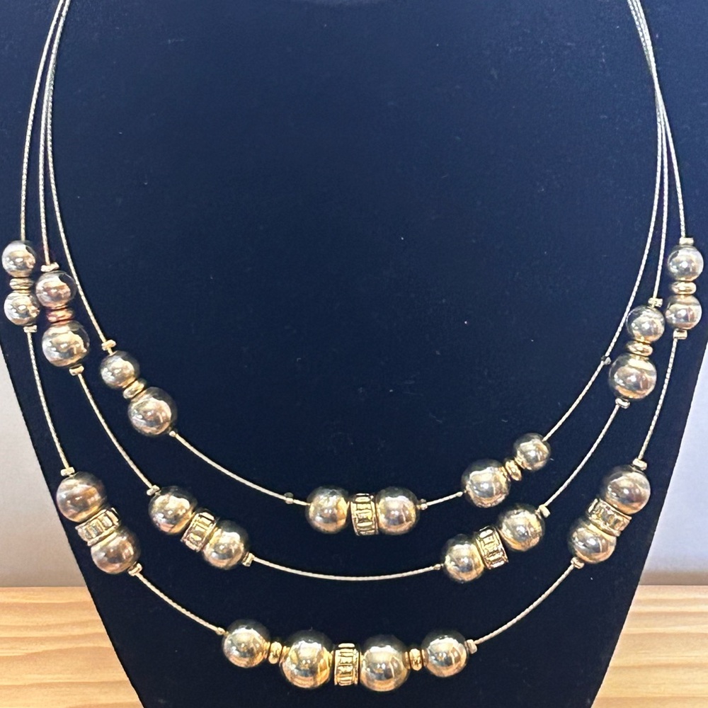 Women’s Gold Tone Beaded 3 layer strand necklace. Adjustable 19 inch length.